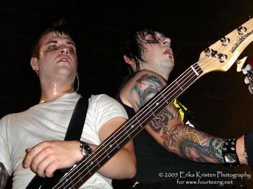 Johnny playing guitar back to back with Zacky