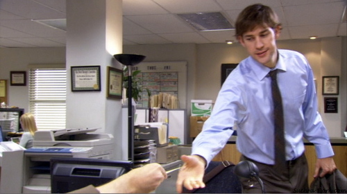  PICTURE THIS: What is Dwight giving Jim in this scene?