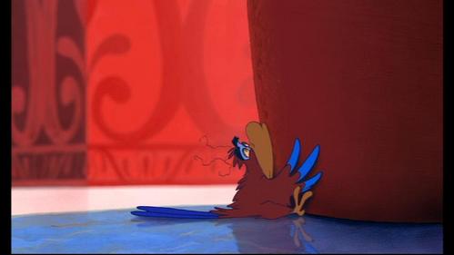  In this scene, after Iago crashes into the wall, what does he see circling around above his head?