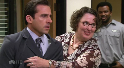 What does the label say on the woman's suit that Michael wears?